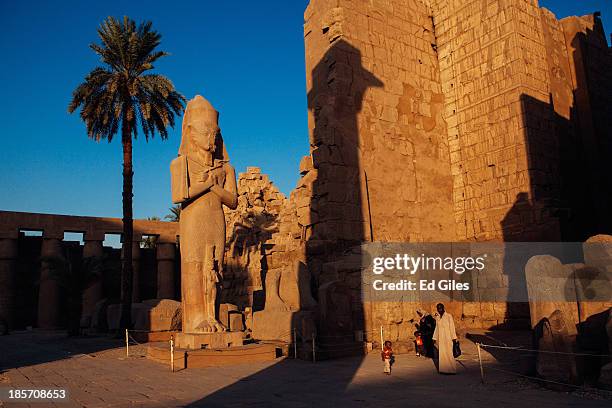 An Egyptian family walk through the Karnak Temple on October 22, 2013 in Luxor, Egypt. Karnak is the largest ancient religious site in the world,...