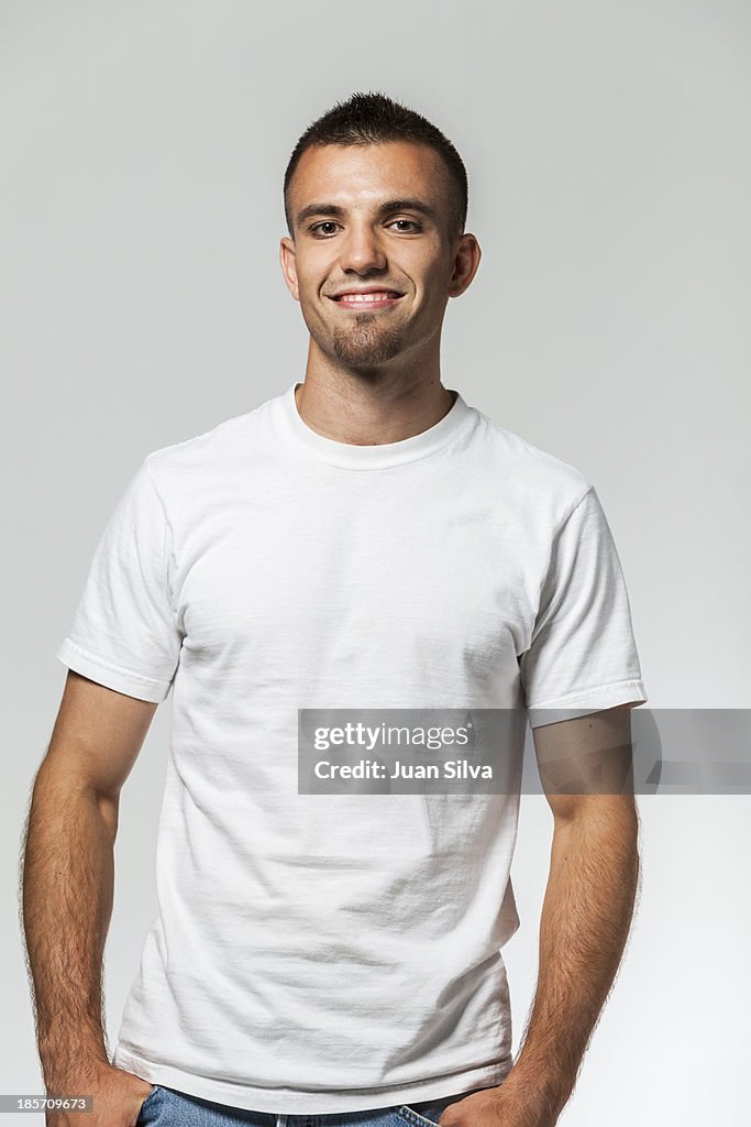 Young man with blue jeans and T-Shirt smiling