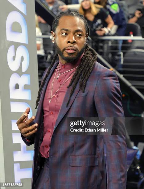 Analyst Richard Sherman takes a break during the "Thursday Night Football" broadcast before a game between the Los Angeles Chargers and the Las Vegas...