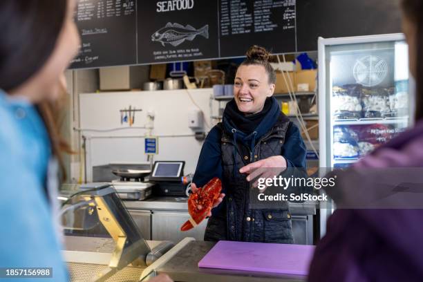 fishmonger selling to customers - lobster seafood stock pictures, royalty-free photos & images