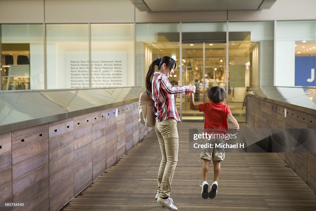 Young mother and child having fun at shop