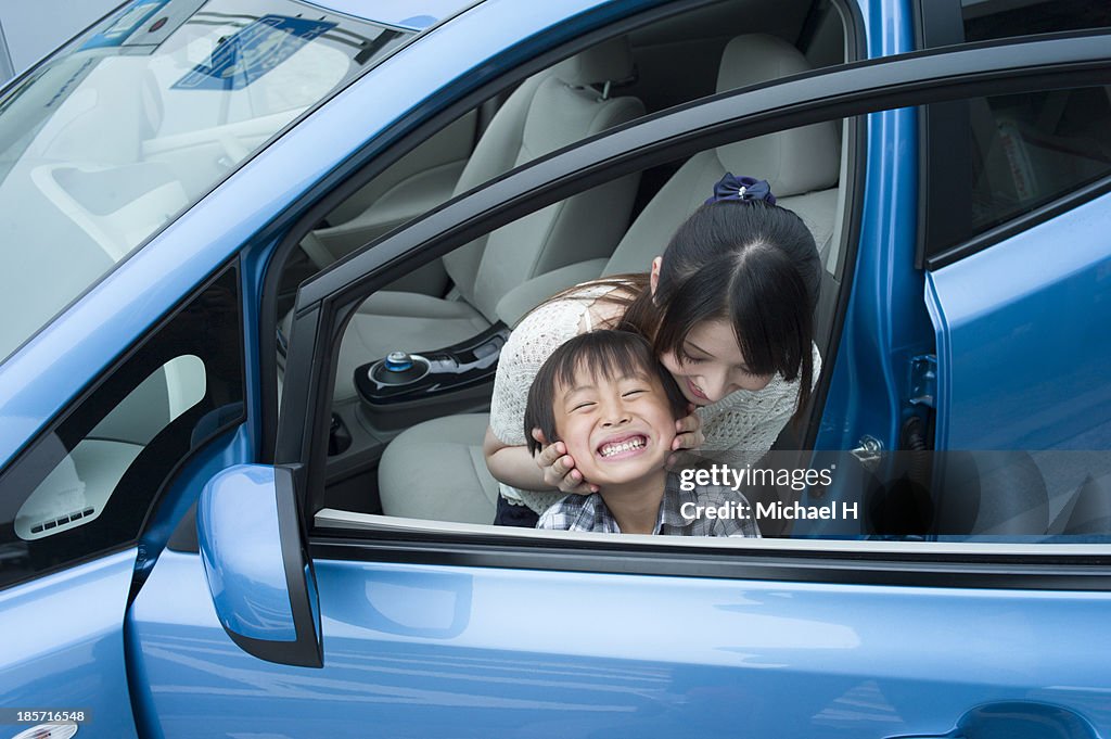 Mother and child in electric car