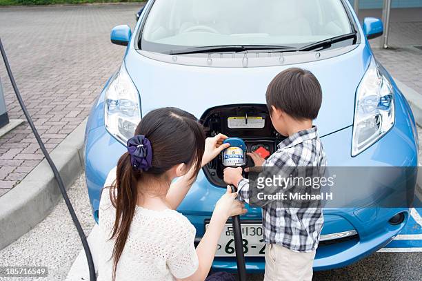 boy charging Electric Car
