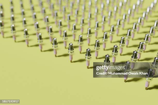 spark plug pattern on yellow background - spark plug stock pictures, royalty-free photos & images