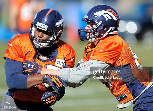 Denver Broncos tight end Virgil Green and Denver Broncos tight end Joel Dreessen get in blocking drills during practice October 24, 2013 at Dove...