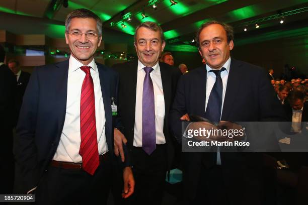 Adidas chairman Herbert Hainer, DFB president Wolfgang Niersbach and UEFA president Michel Platini pose prior to the DFB Bundestag at the NCC...