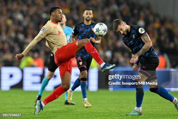 Morgan Guilavogui of RC Lens fighting for the ball with Nemanja Gudelj of Sevilla during the Uefa Champions League matchday 6 game in group B in the...