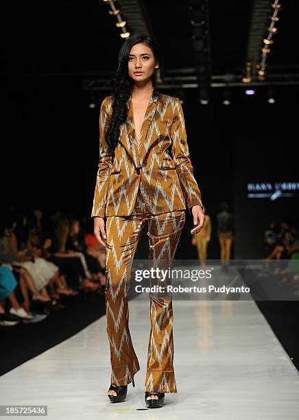 Model showcases designs by Hans Ubbink of Netherlands on the runway at the Erasmus Huis show during Jakarta Fashion Week 2014 at Senayan City on...