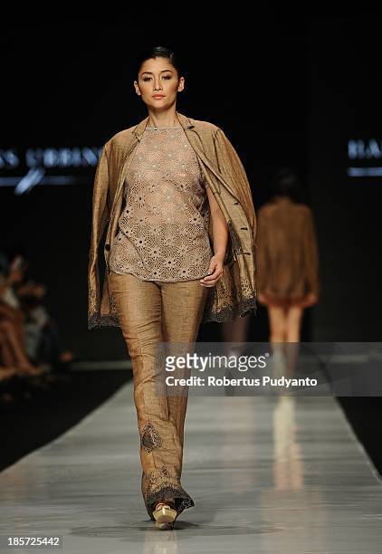Model showcases designs by Hans Ubbink of Netherlands on the runway at the Erasmus Huis show during Jakarta Fashion Week 2014 at Senayan City on...