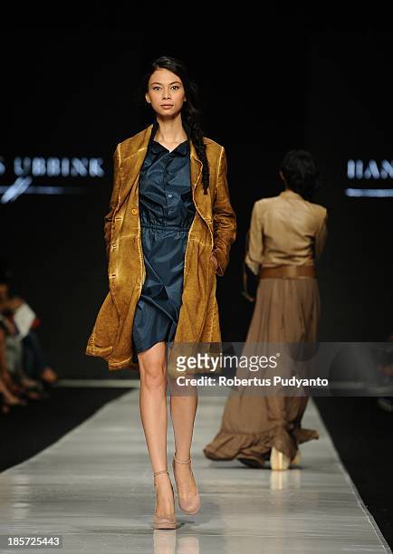 Model showcases designs by Hans Ubbink of Netherlands on the runway at the Erasmus Huis show during Jakarta Fashion Week 2014 at Senayan City on...