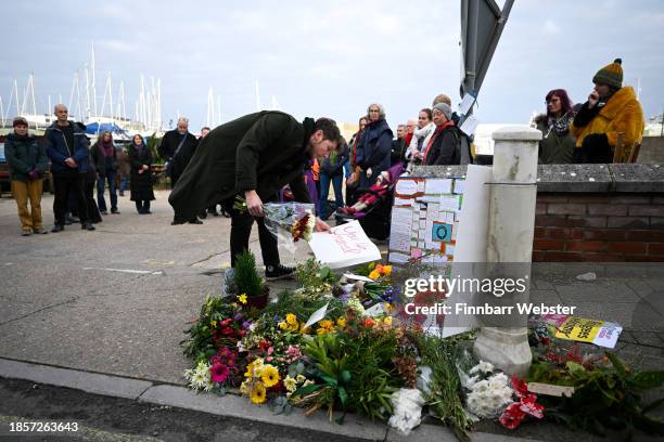 People pay their respects at the vigil for the deceased asylum seeker, outside Portland Port, on December 15, 2023 in Portland, England. Stand Up to...