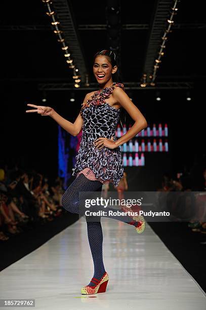 Model showcases designs by Lenni Agustin on the runway at the Body Shop show during Jakarta Fashion Week 2014 at Senayan City on October 24, 2013 in...