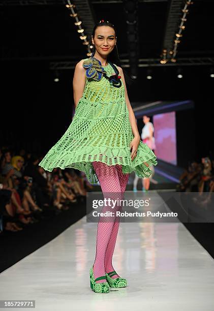 Model showcases designs by Lenni Agustin on the runway at the Body Shop show during Jakarta Fashion Week 2014 at Senayan City on October 24, 2013 in...