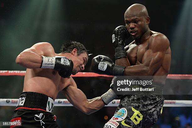 Juan Manuel Marquez punches WBO welterweight champion Timothy Bradley Jr. In the body during their bout at the Thomas & Mack Center on October 12,...