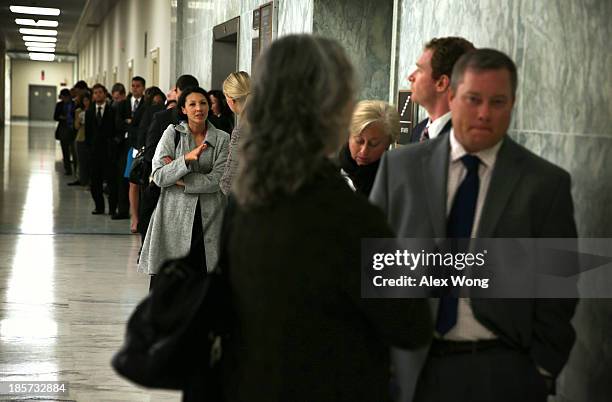 People wait in line for a hearing on implementation of the Affordable Care Act before the House Energy and Commerce Committee October 24, 2013 on...