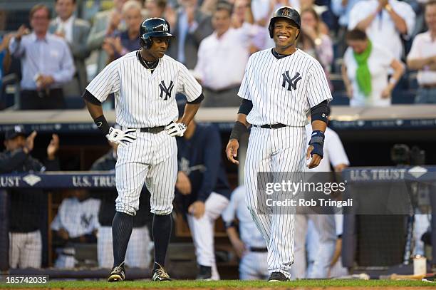 Robinson Cano of the New York Yankees celebrates with Alex Rodriguez and Curtis Granderson after Alfonso Soriano hits a 1st inning home run against...