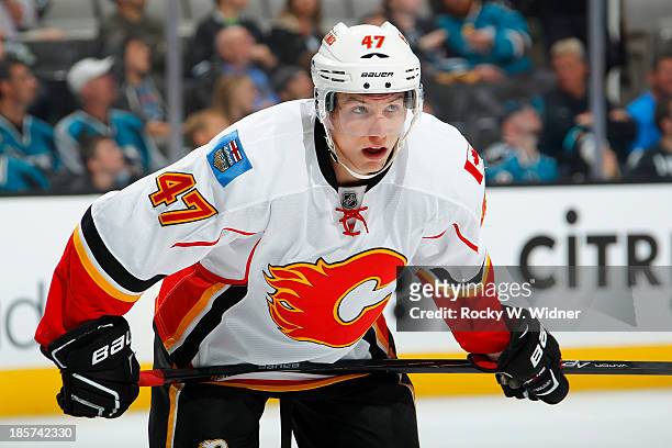 Sven Baertschi of the Calgary Flames in a faceoff against the San Jose Sharks at SAP Center on October 19 2013 in San Jose, California.