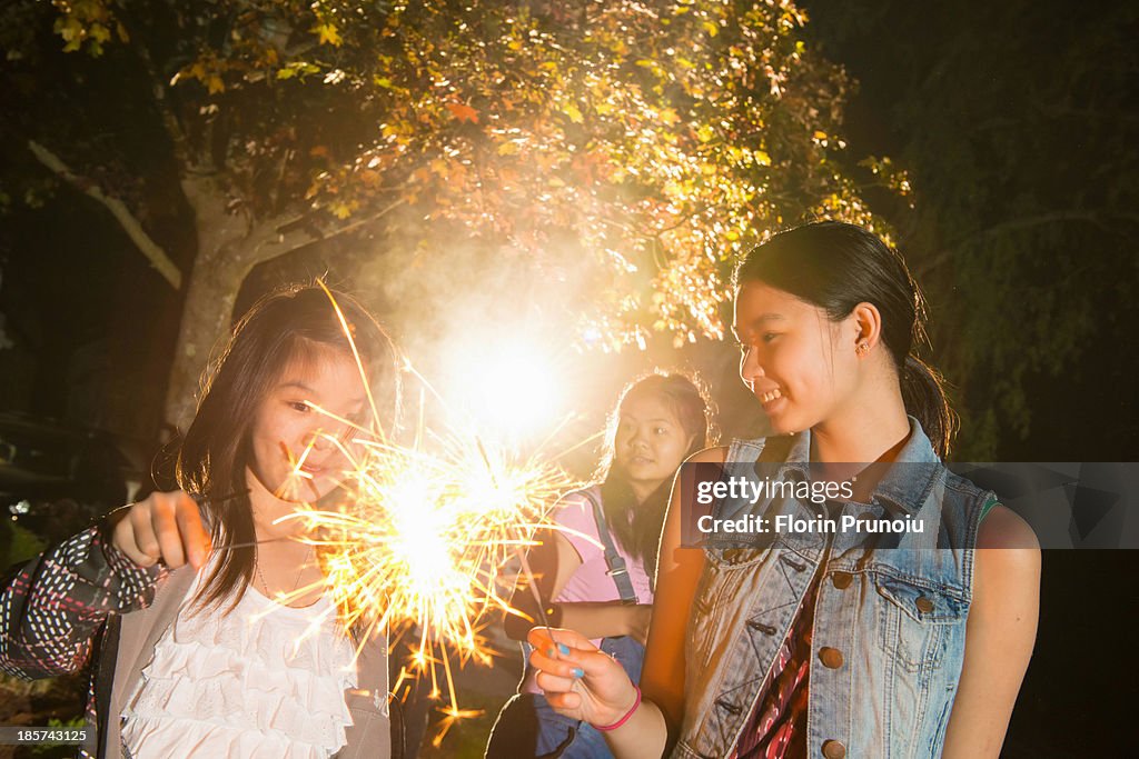 Girl with sparkler at night