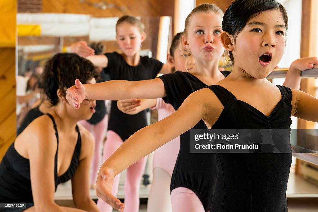 Ballerinas practising at the barre in ballet school