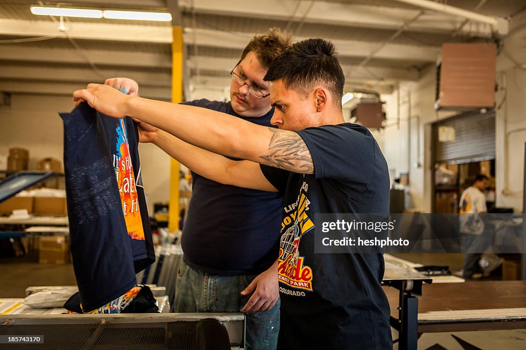 Workers checking quality in screen print workshop