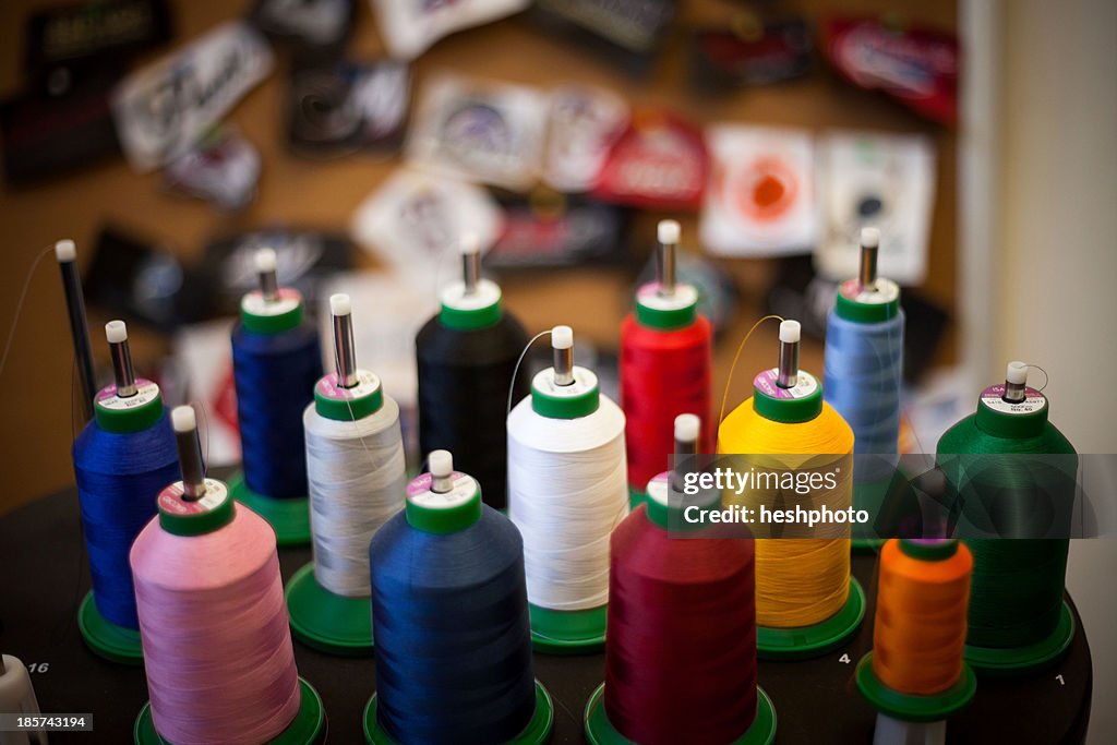 Group of embroidery thread bobbins on machine
