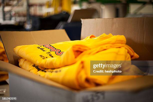 open cardboard box containing screen printed t-shirts - heshphoto - fotografias e filmes do acervo