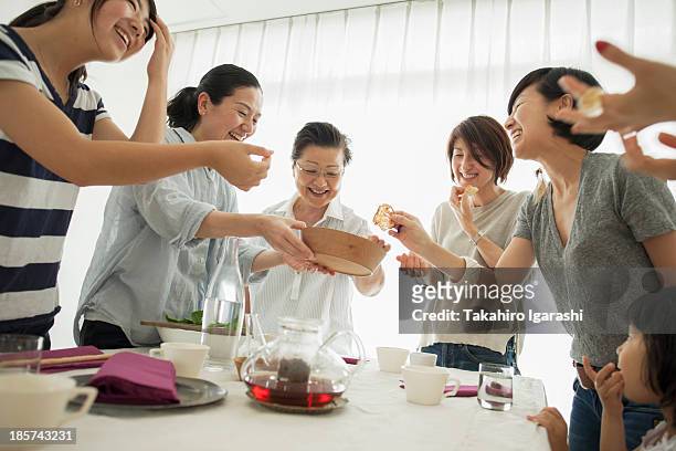 three generation family laughing at mealtime - nur japaner stock-fotos und bilder