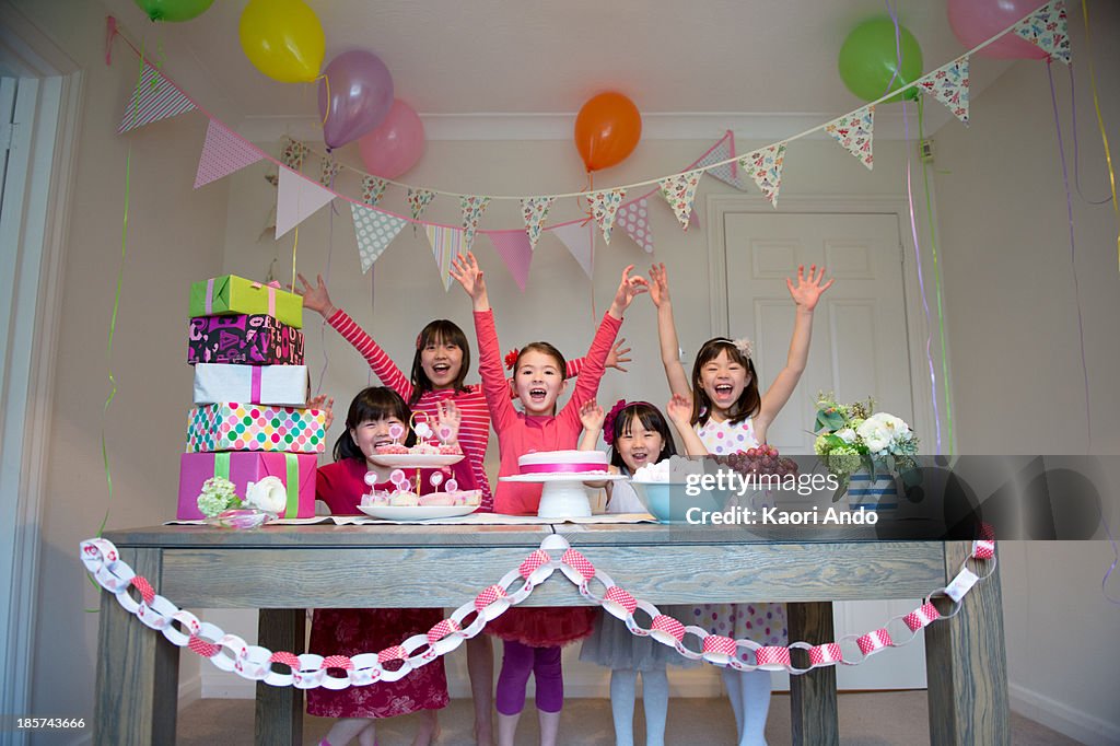 Girls cheering at birthday party