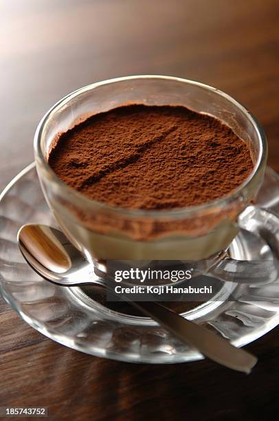 still life of cup of coffee dessert with chocolate powder on top - ティラミス　ガラス ストックフォトと画像