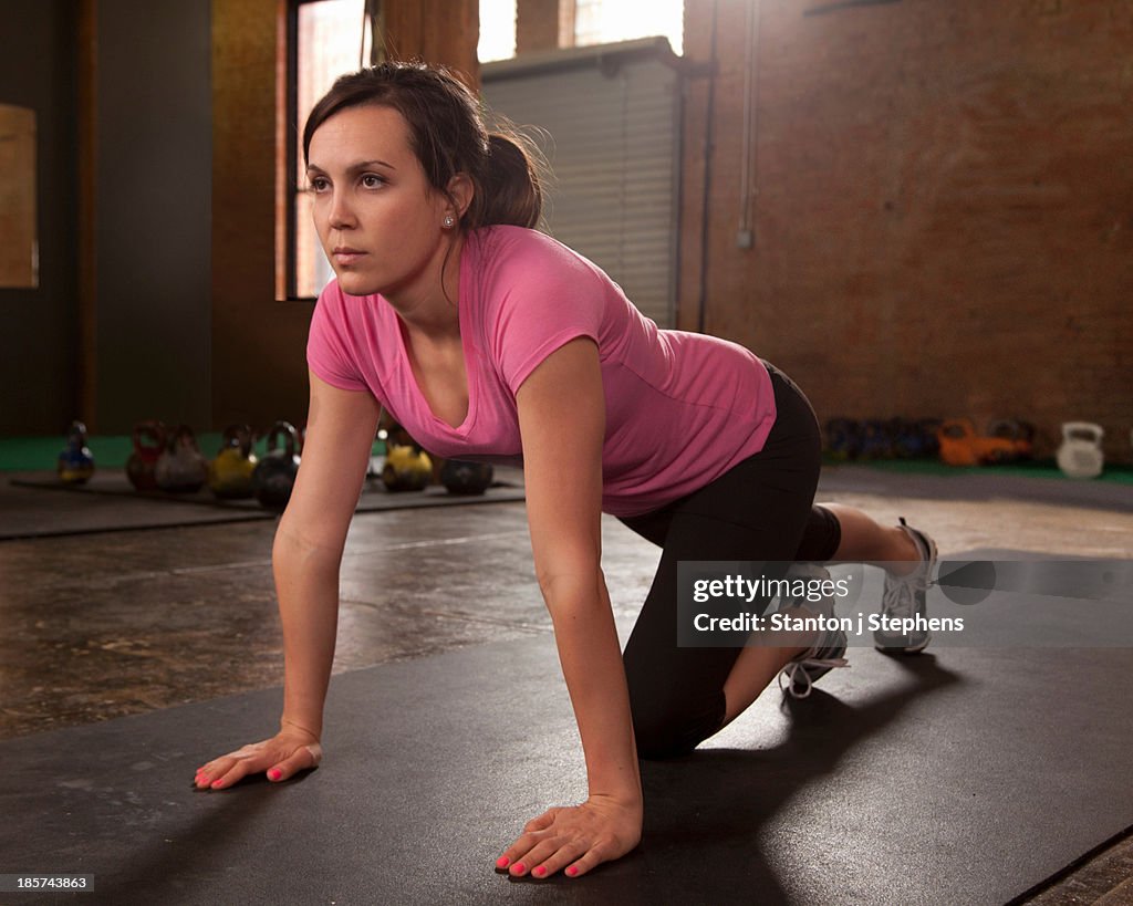 Young woman exercising in gym