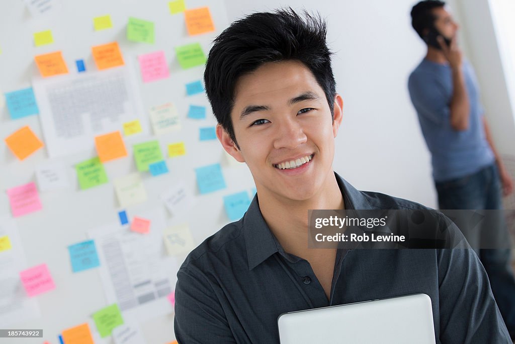 Male office worker holding digital tablet