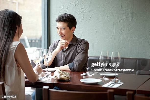 Young couple laughing in restaurant