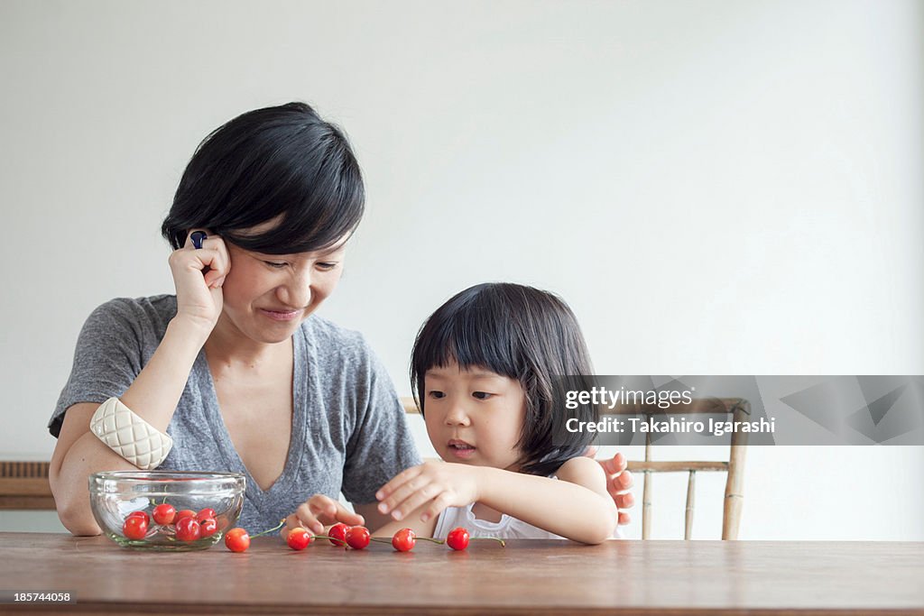 Mother and daughter counting cherries