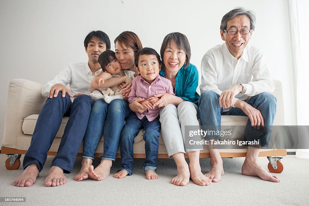 Three generation family sitting on sofa,  portrait