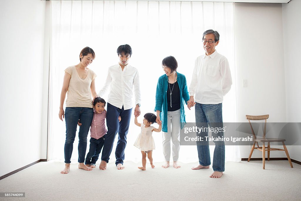 Three generation family holding hands, portrait