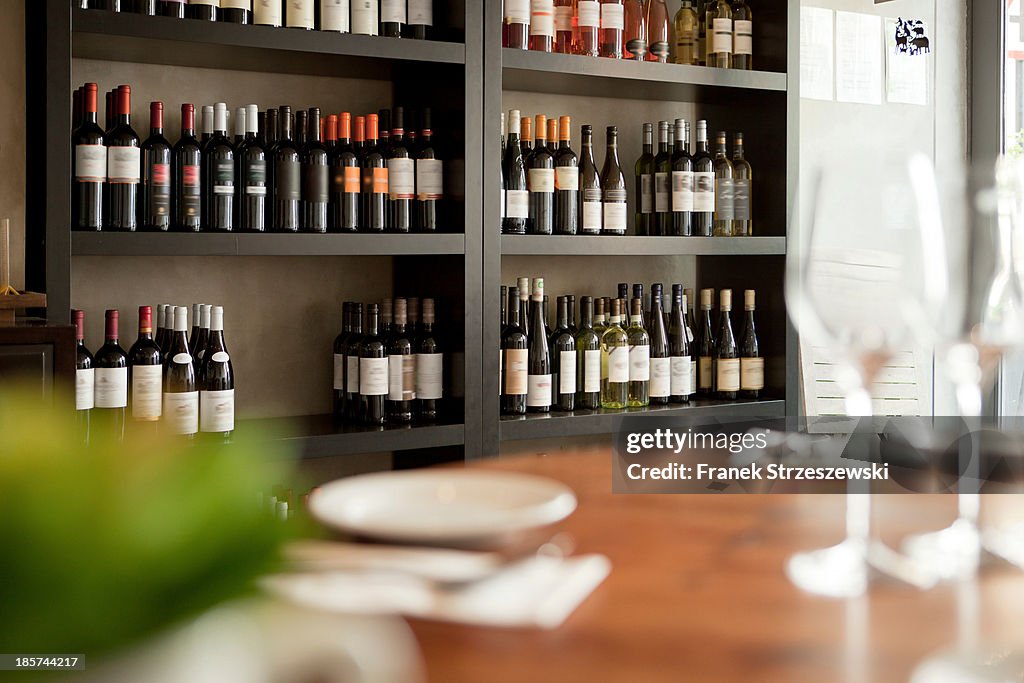 Wine bottles on shelves in restaurant