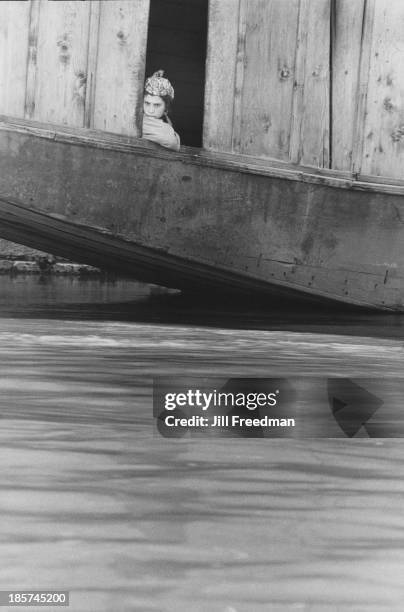 Girl looks across the water from a houseboat in Srinagar, Kashmir, India, 1978.