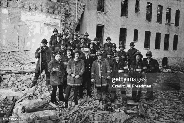 Four companies from the FDNY pose for a picture amongst rubble in the South Bronx, New York City, 1976.