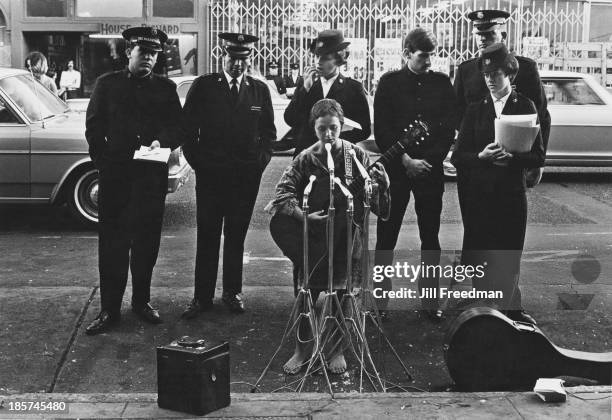 Street musician sings along with the Salvation Army band in San Francisco, 1968.