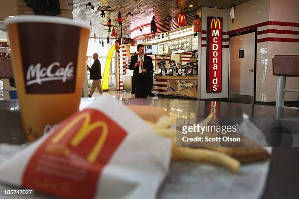 In this photo illustration, customers order food from a McDonald's restaurant on October 24, 2013 in Des Plaines, Illinois. McDonald's has announced...