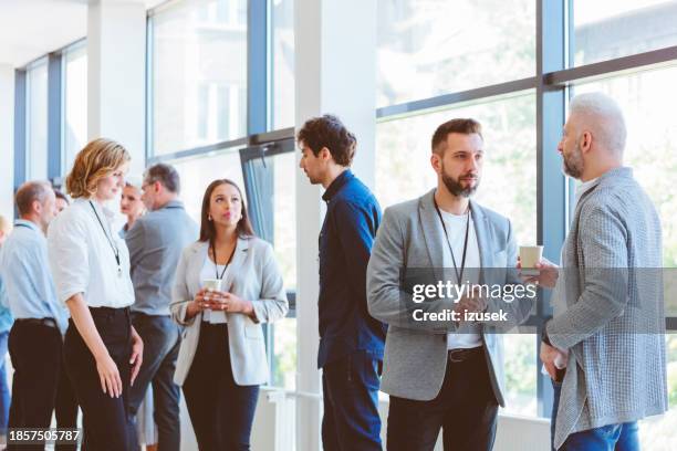business people in convention center during coffee break - connection stock pictures, royalty-free photos & images