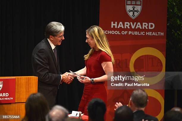 Chelsea Clinton receives the Next Generation Award from Harvard School of Public Health Dean of Faculty Julio Frenk on October 24, 2013 in Boston,...