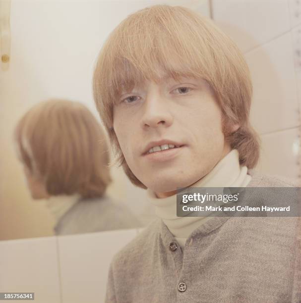 1st JANUARY: English guitarist and member of The Rolling Stones Brian Jones posed backstage in 1965.