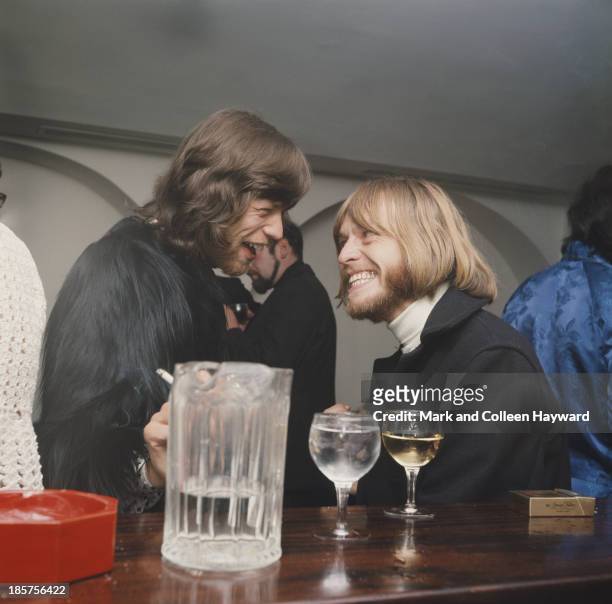 28th JANUARY: Mick Jagger and Brian Jones from The Rolling Stones talk together at a party to celebrate the cabaret debut of the Supremes on Kings...