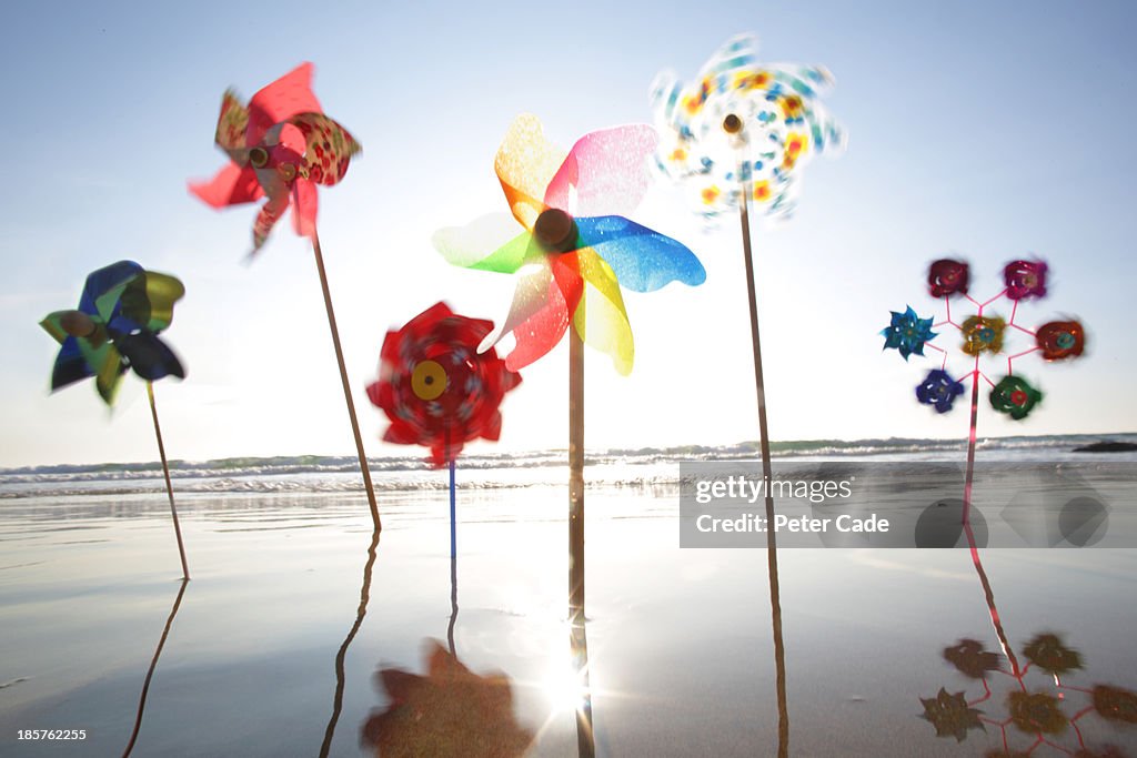 Windmills in the sand at the waters edge