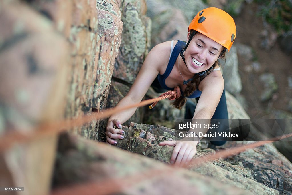 Girl rock having fun while rock climbing.