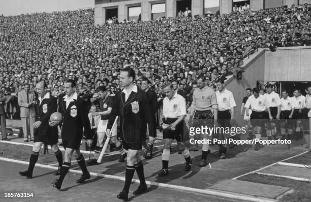 Officials lead out the teams before a friendly international between England and Hungary at the Nepstadion, Budapest, 23rd May 1954. The England...