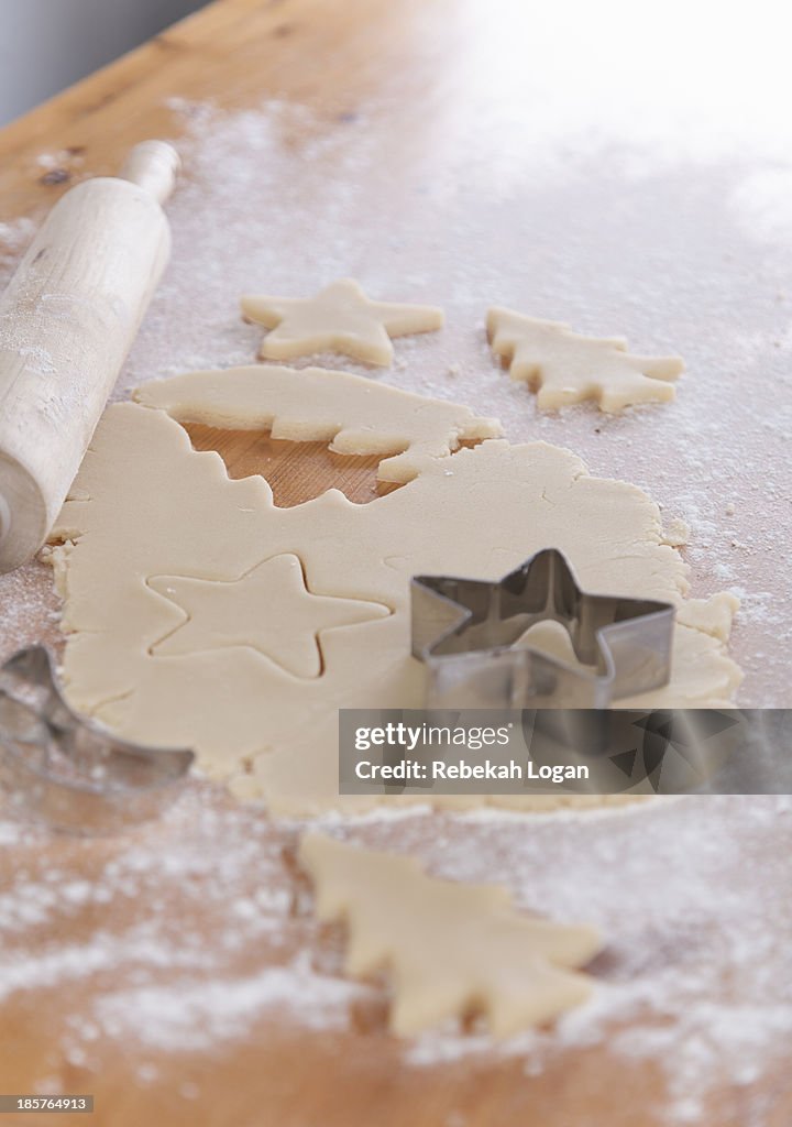 Star and tree shaped cookie cutters and pastry.