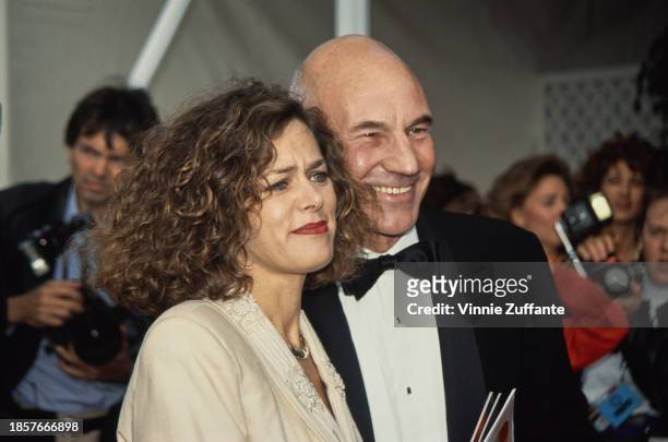 American businesswoman Meridith Baer, wearing an ivory-coloured suit, and British actor Patrick Stewart, who wears a tuxedo and bow tie, attend the...