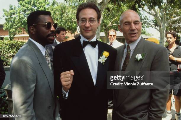 American actor LeVar Burton, wearing a grey suit and sunglasses, American actor Brent Spiner, in a tuxedo and bow tie, and British actor Patrick...